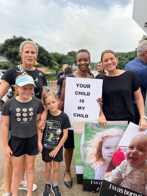 'Your child is my child' placard