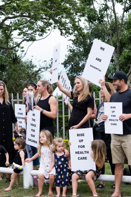 'Rise up for health care' placards