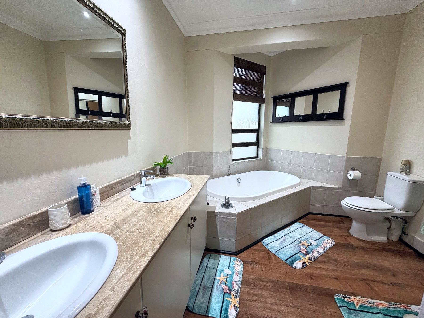 Main bathroom with double basins and oval bath