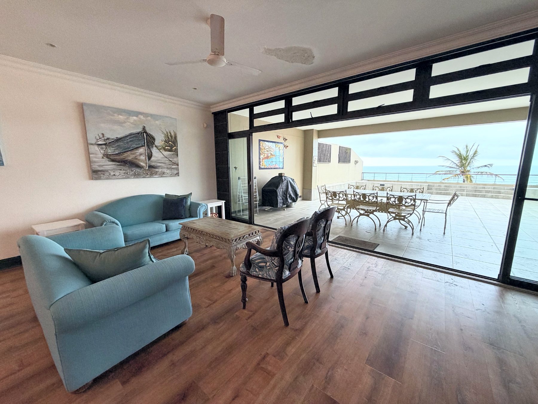 Living room opening onto the balcony and the sea