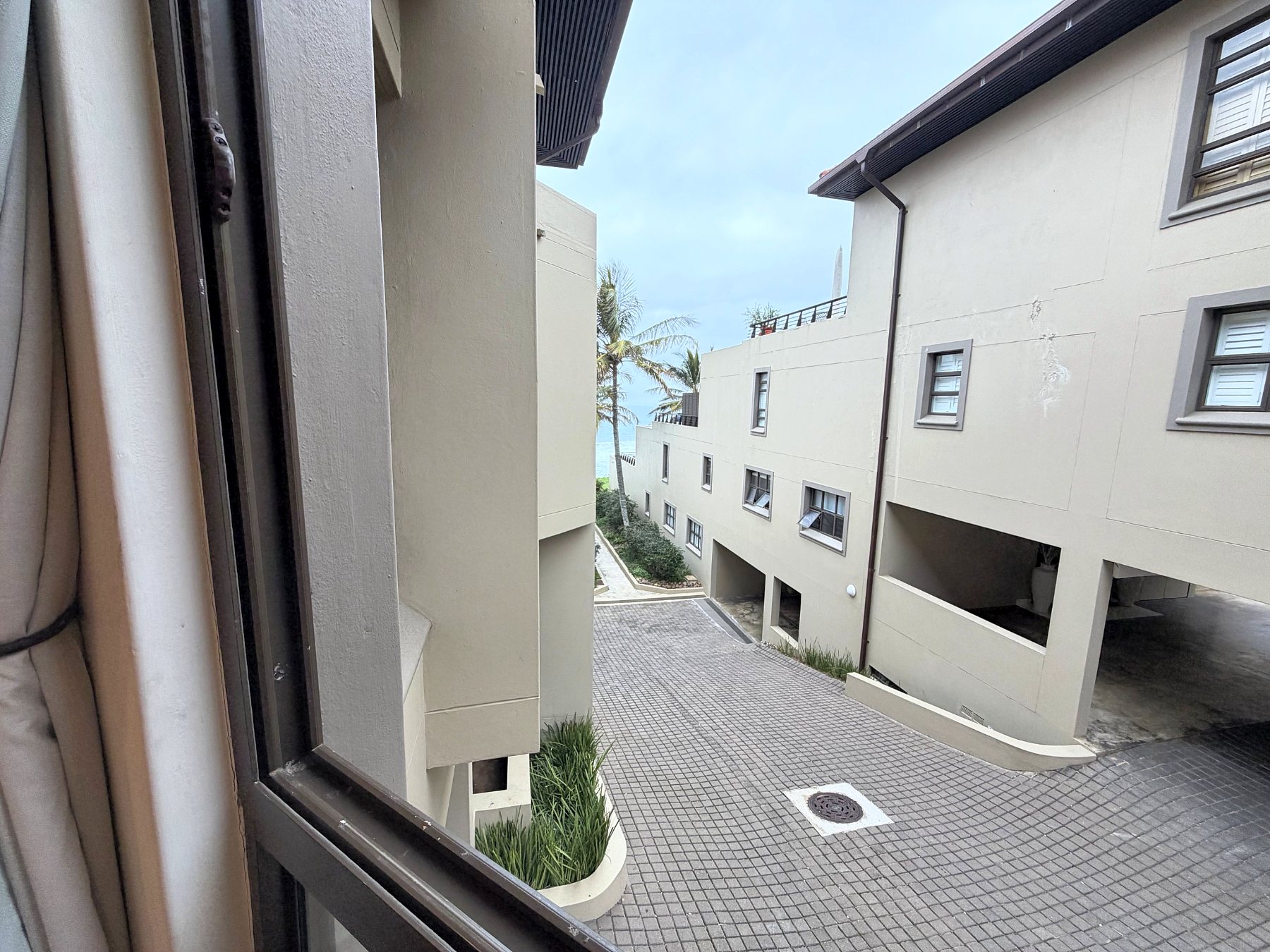 View from the third bedroom window down the complex towards the sea