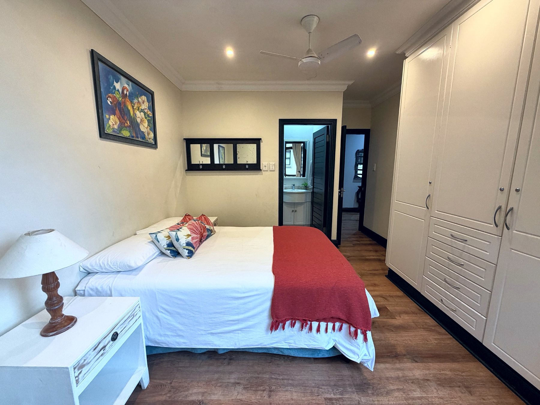 Second bedroom with king bed, built-in cupboards and en-suite
